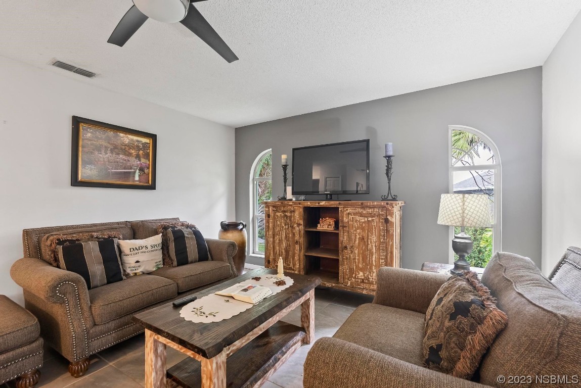 1829 Lime Tree Drive Edgewater, FL 32132 - Photo 13 of 62 a living room with furniture and a fireplace