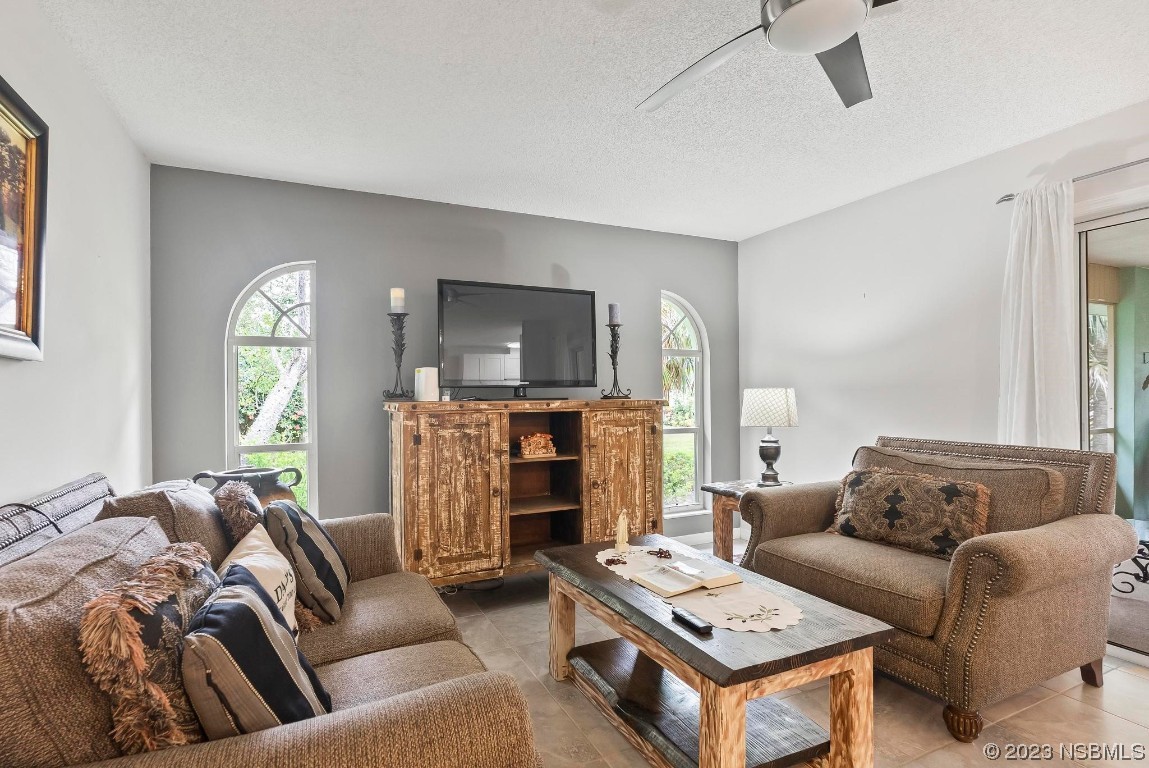 1829 Lime Tree Drive Edgewater, FL 32132 - Photo 14 of 62 a living room with furniture and a fireplace