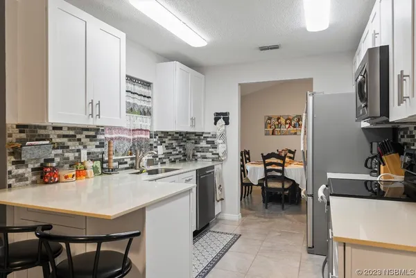 a kitchen with granite countertop a sink and a stove top oven