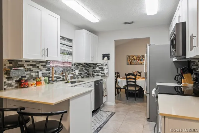 a kitchen with granite countertop a sink and a stove top oven