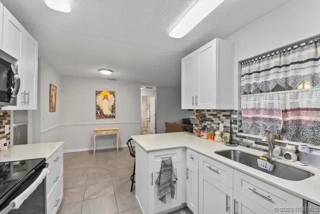 a kitchen with stainless steel appliances kitchen island granite countertop a sink and cabinets
