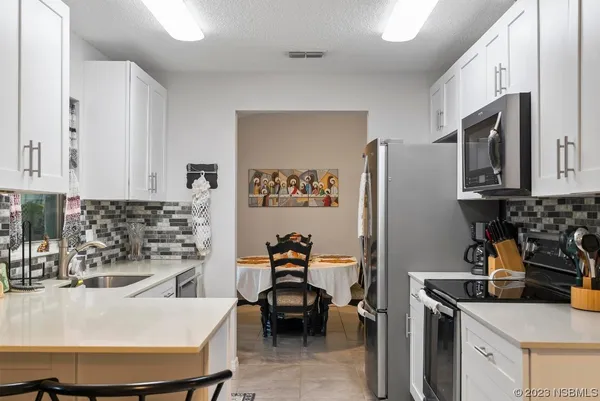 a kitchen with an oven and cabinets