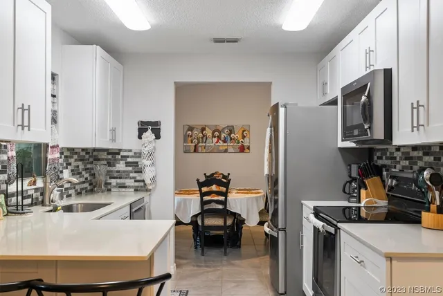 a kitchen with an oven and cabinets