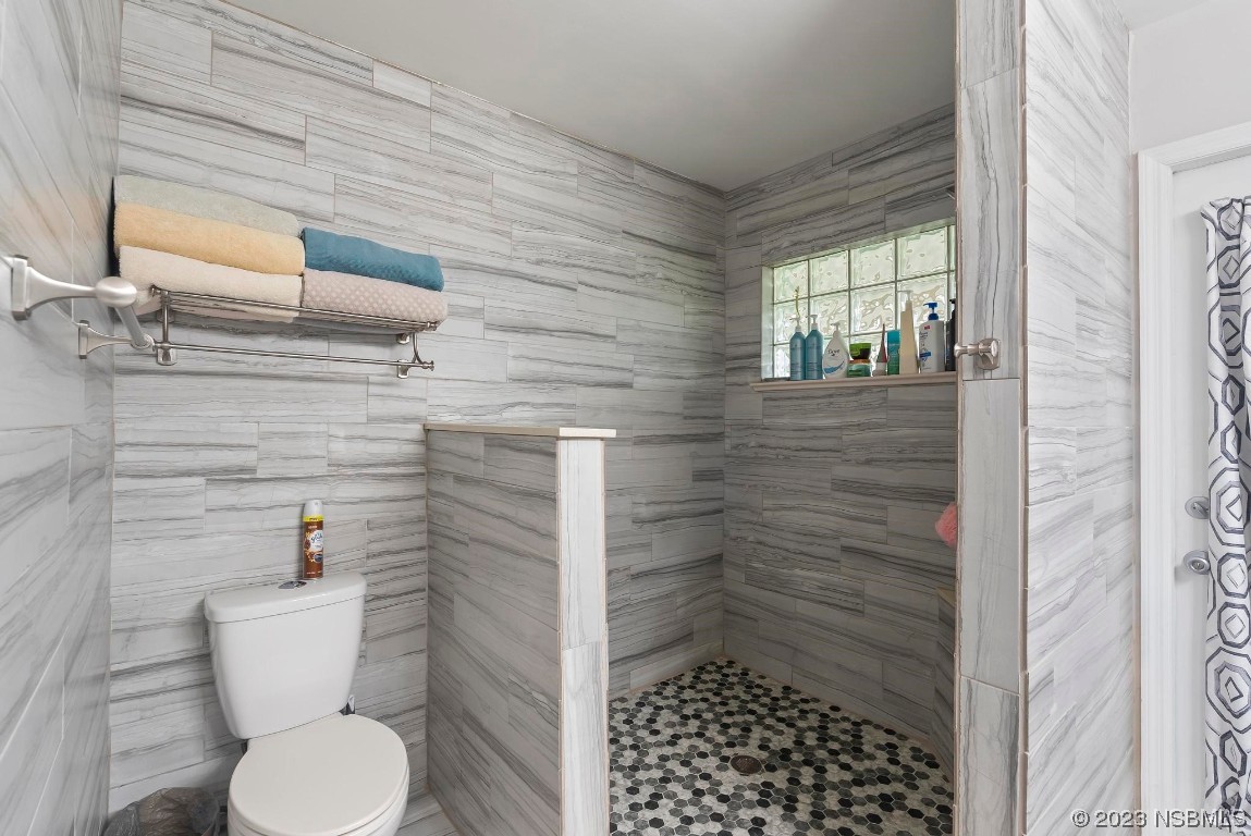 1829 Lime Tree Drive Edgewater, FL 32132 - Photo 35 of 62 a bathroom with a toilet and a shower