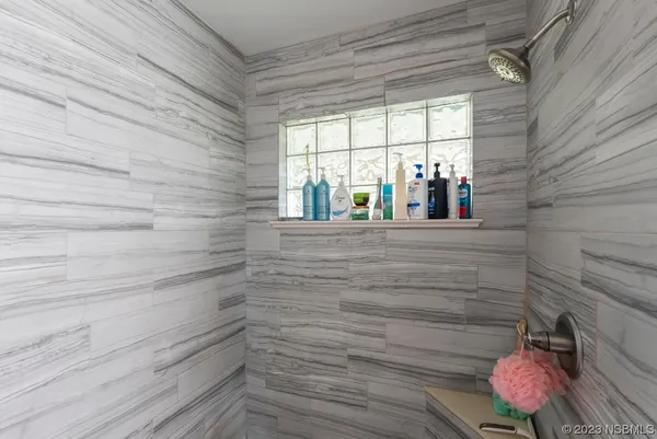 a view of a chair and table in backyard of the house