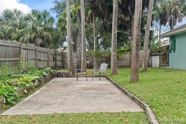 a view of a house with a yard and tree s