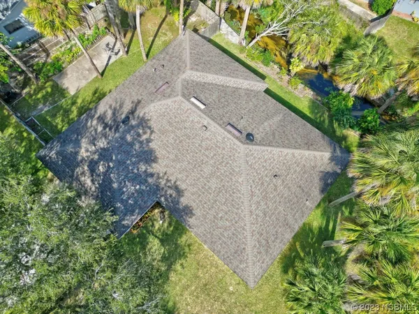 an aerial view of a house with a yard