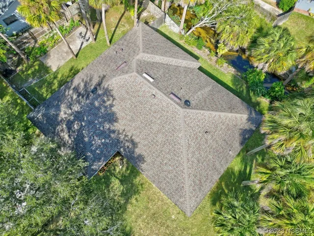 an aerial view of a house with a yard