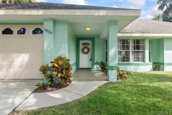 a view of a hallway with wooden floor and a cabinet