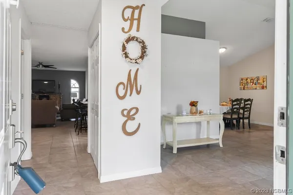 a living room with furniture a fireplace and a large window