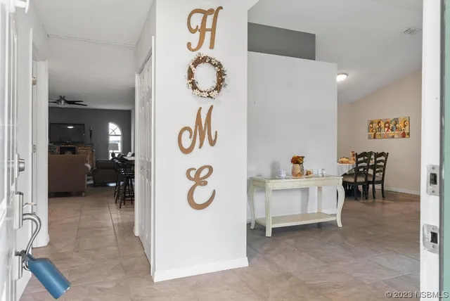 a living room with furniture a fireplace and a large window