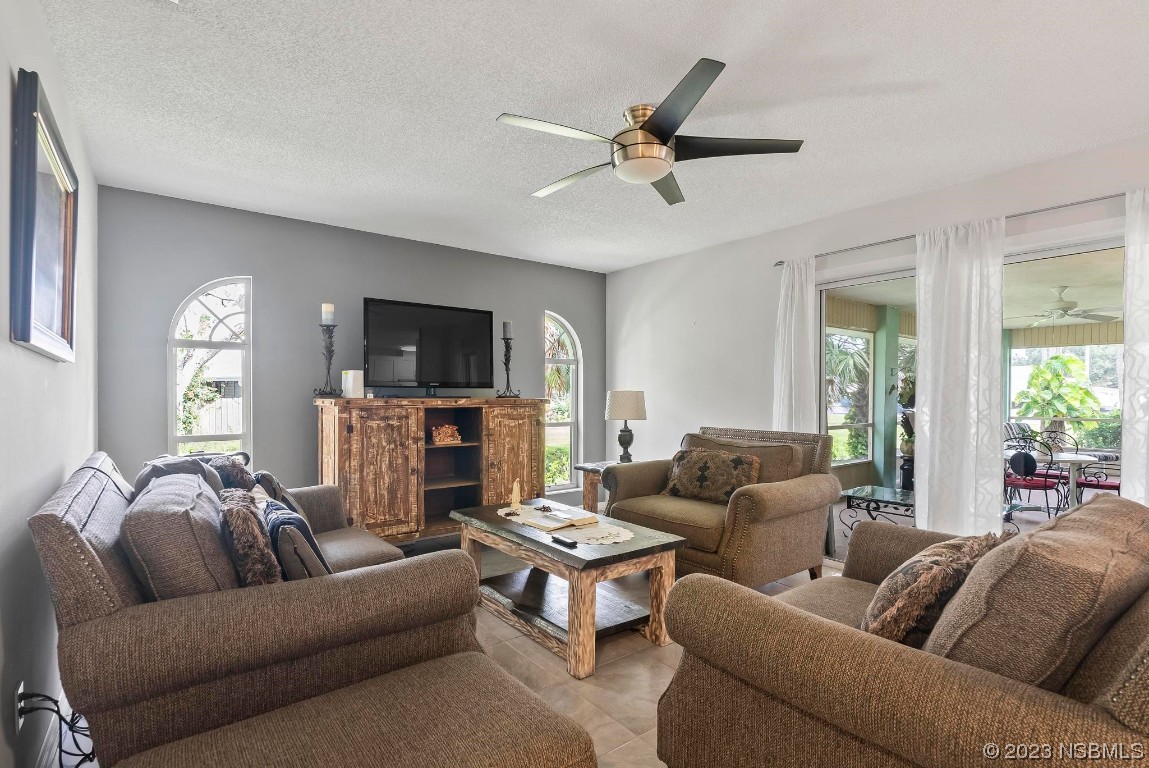 1829 Lime Tree Drive Edgewater, FL 32132 - Photo 10 of 62 a living room with furniture and a flat screen tv