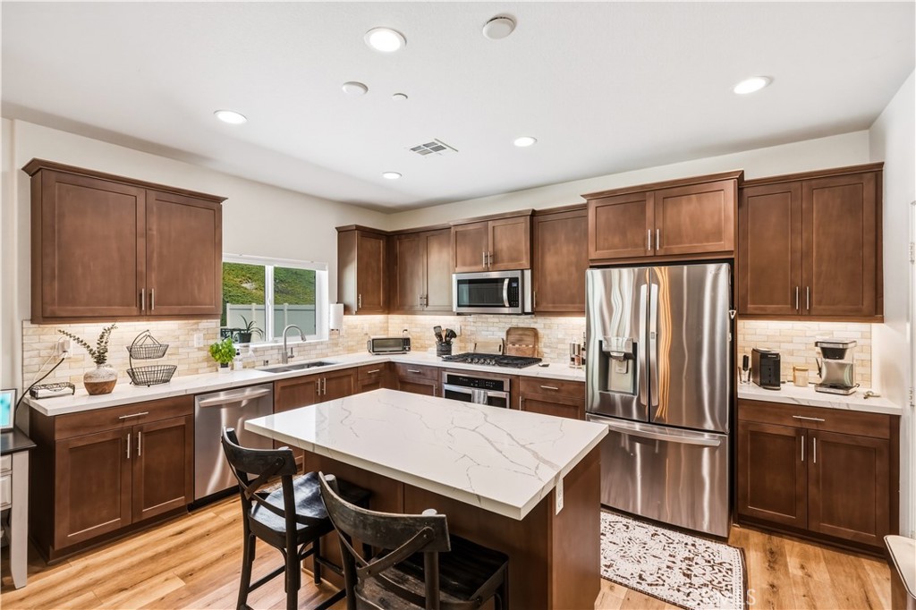 29853 White Ridge Road Winchester, CA 92596 - Photo 9 of 61 Island kitchen with quartz and stainless steel