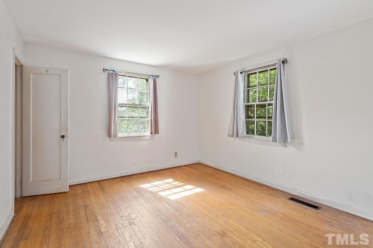 1208 Clifton Street Raleigh, NC 27604 - Photo 26 of 33 an empty room with wooden floor and windows