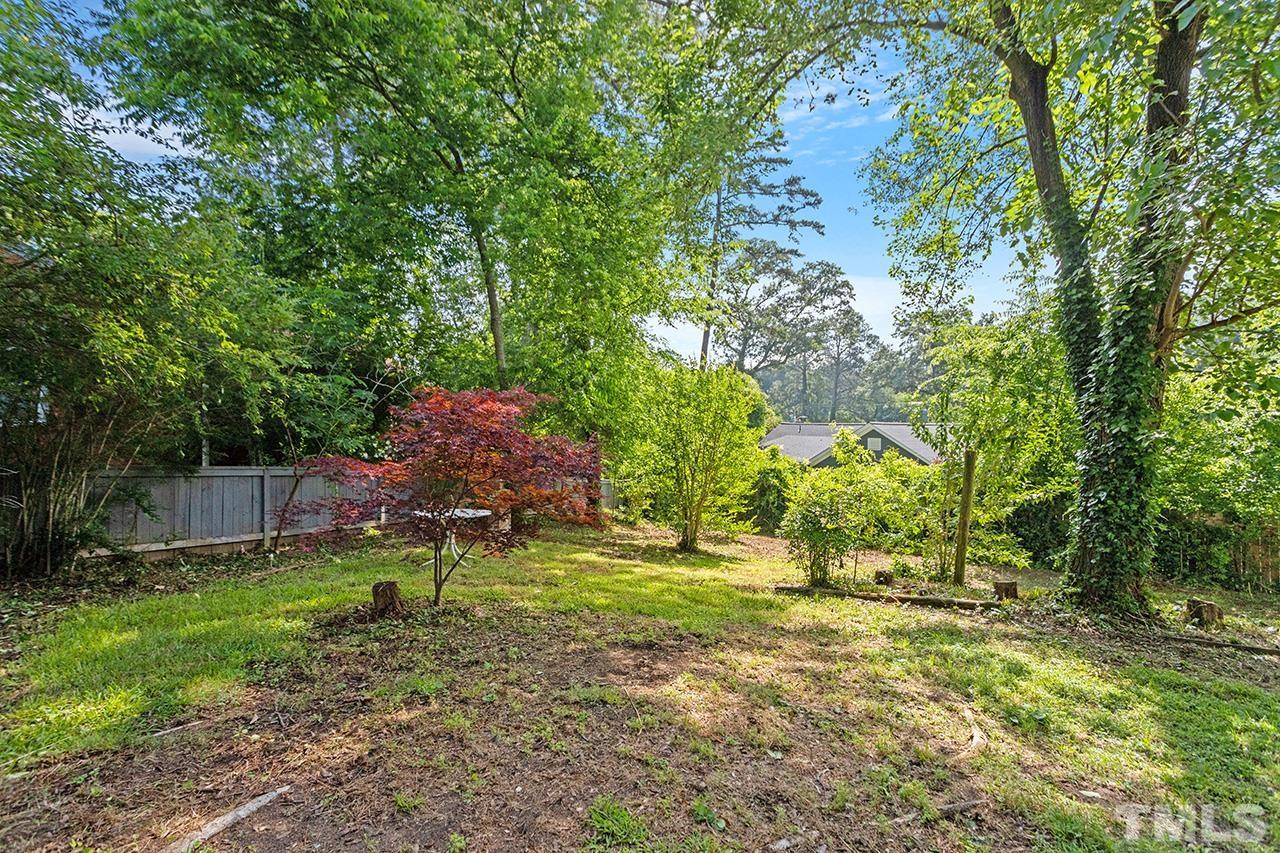 1208 Clifton Street Raleigh, NC 27604 - Photo 5 of 33 a backyard of a house with lots of green space