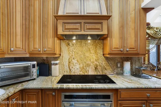 a living room with fireplace furniture and a floor to ceiling window