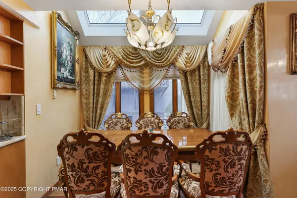 a living room with furniture a flat screen tv and kitchen view