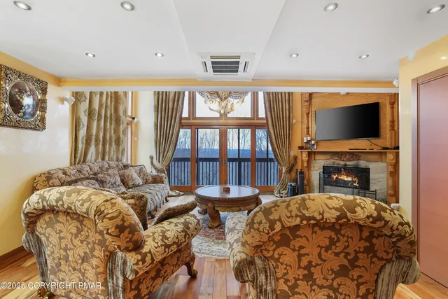 a living room with furniture and a wooden floor