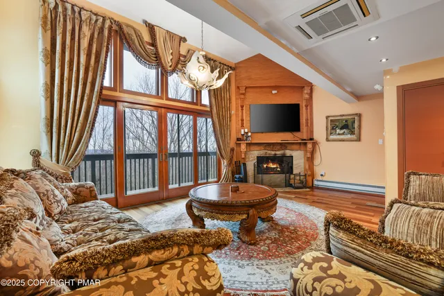 a living room with furniture a fireplace and a flat screen tv