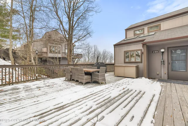 a front view of a house with a yard covered in snow