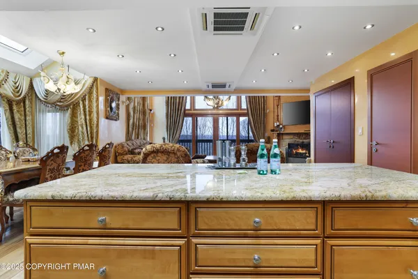 a kitchen with stainless steel appliances granite countertop a sink a stove and cabinets