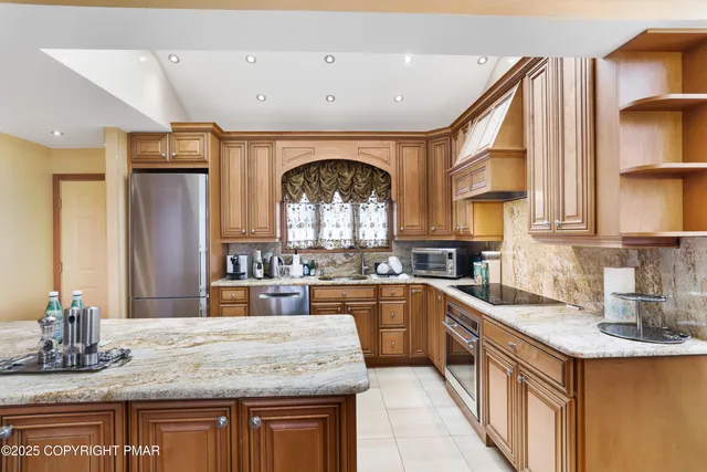 a kitchen with granite countertop a stove and cabinets