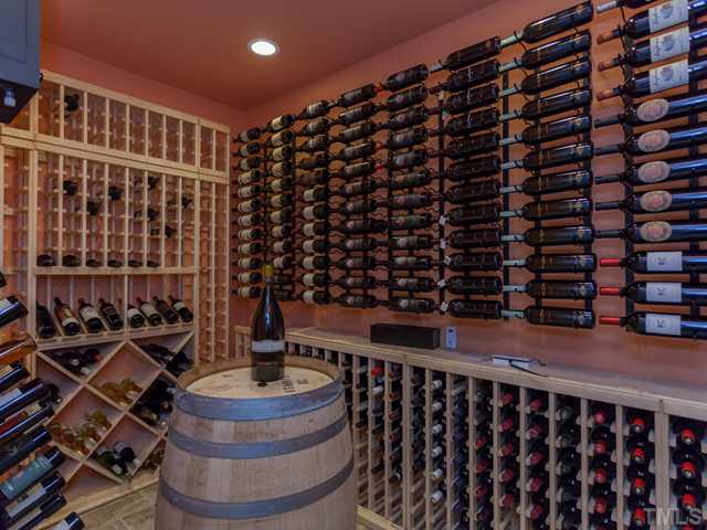 4736 Adler Pass Raleigh, NC 27612 - Photo 20 of 25 The rack arrangement in the wine cellar is a work of art. The wine room chiller and the wine racks convey with the home. A special lock is on the door to this appealing room.