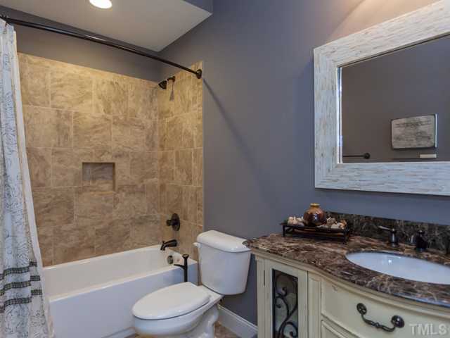 4736 Adler Pass Raleigh, NC 27612 - Photo 22 of 25 This elegant bathroom with its custom vanity and decorative mirror is located in the basement.