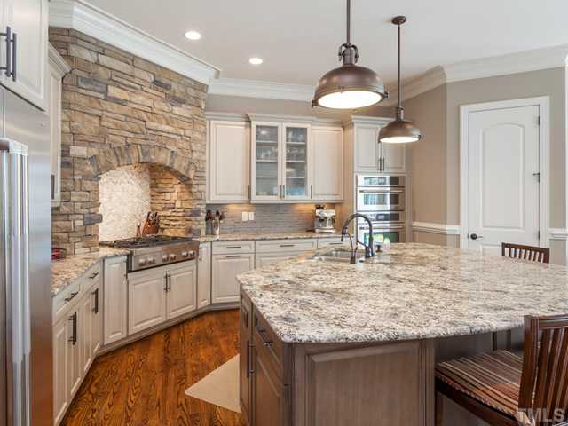 4736 Adler Pass Raleigh, NC 27612 - Photo 6 of 25 This is one of the most beautiful kitchens that you will ever see! The gas cook top is framed with stone surround. The large island is crowned with a majestic piece of granite. Additional features include tile back splash and under cabinet lighting.
