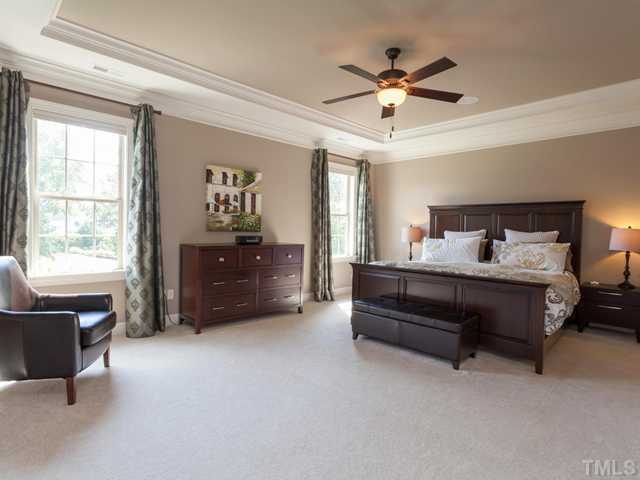 4736 Adler Pass Raleigh, NC 27612 - Photo 9 of 25 The elegant master retreat offers two large walk in closets, heavy crown molding, distributed audio, custom shades, and a ceiling fan. It overlooks the lovely backyard.