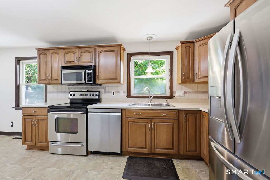 630 South Elm Street Wallingford, CT 06492 - Photo 7 of 30 a kitchen with stainless steel appliances a stove sink and microwave