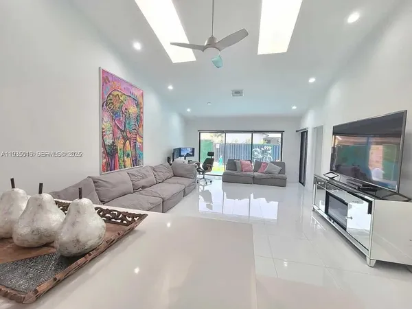 a living room with furniture and a flat screen tv
