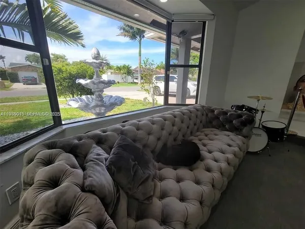 a living room with furniture and a large window
