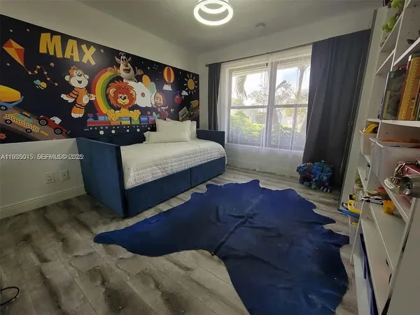 a bedroom with furniture and a window