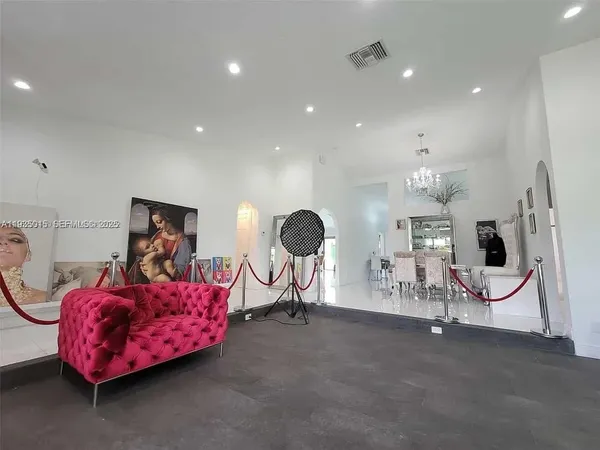 a living room with furniture and a mirror