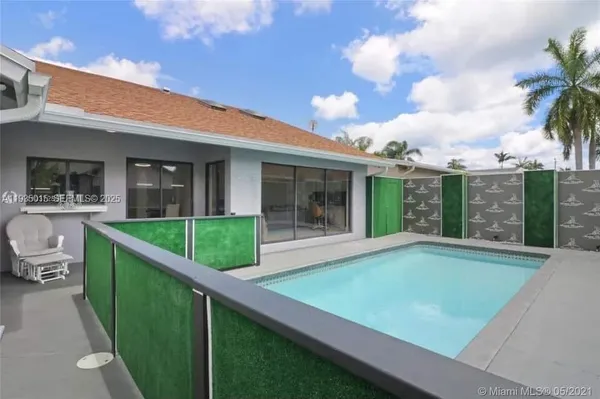 a view of an house with backyard and porch