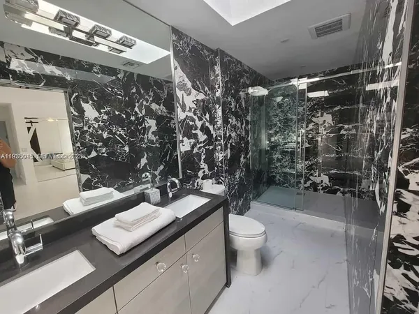 a bathroom with a toilet sink and mirror