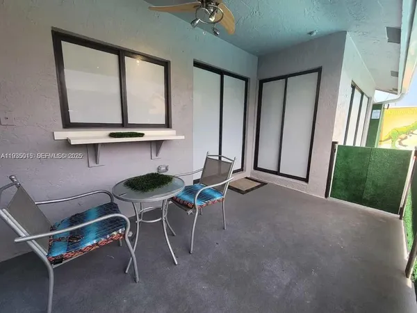 a living room with a table chairs and a wooden floor