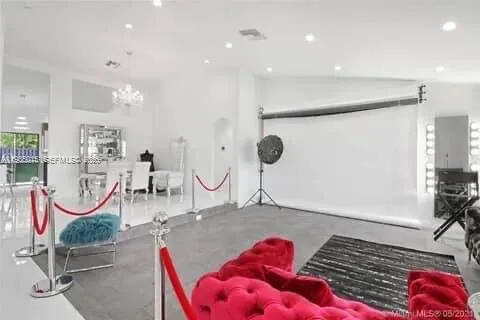 a very nice looking room with lots of white furniture