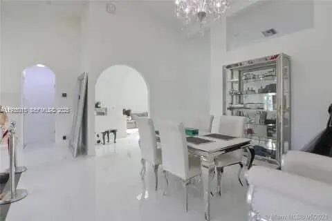 a workspace with furniture and chandelier