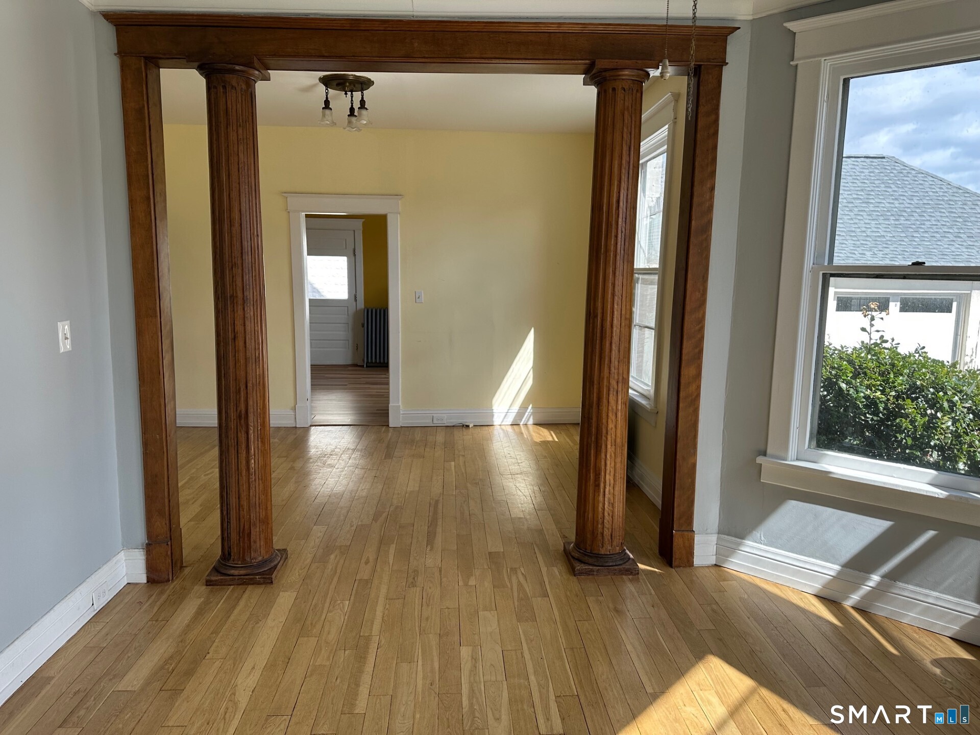 18 Taylor Street Torrington, CT 06790 - Photo 3 of 17 a view of a hallway with wooden floor and windows