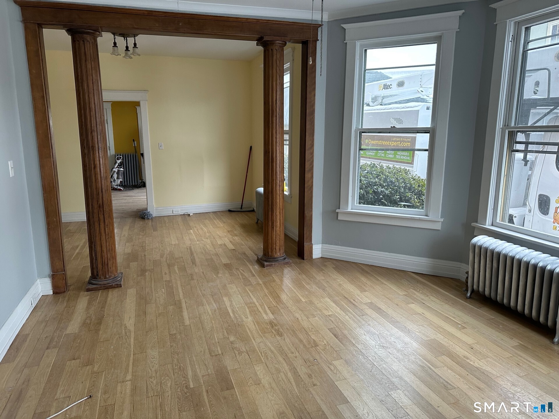 18 Taylor Street Torrington, CT 06790 - Photo 4 of 17 an empty room with wooden floor and windows