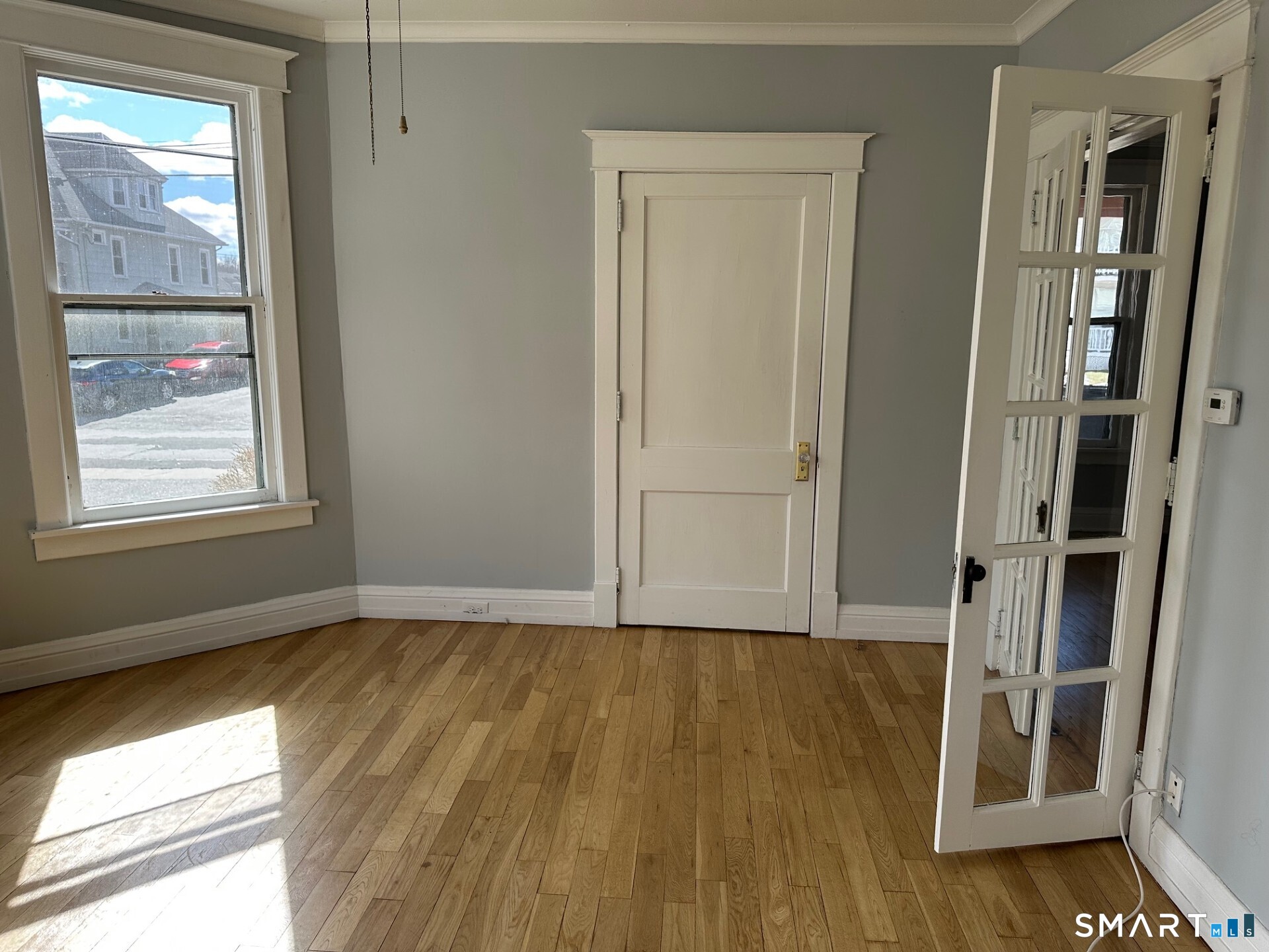 18 Taylor Street Torrington, CT 06790 - Photo 6 of 17 an empty room with wooden floor and windows