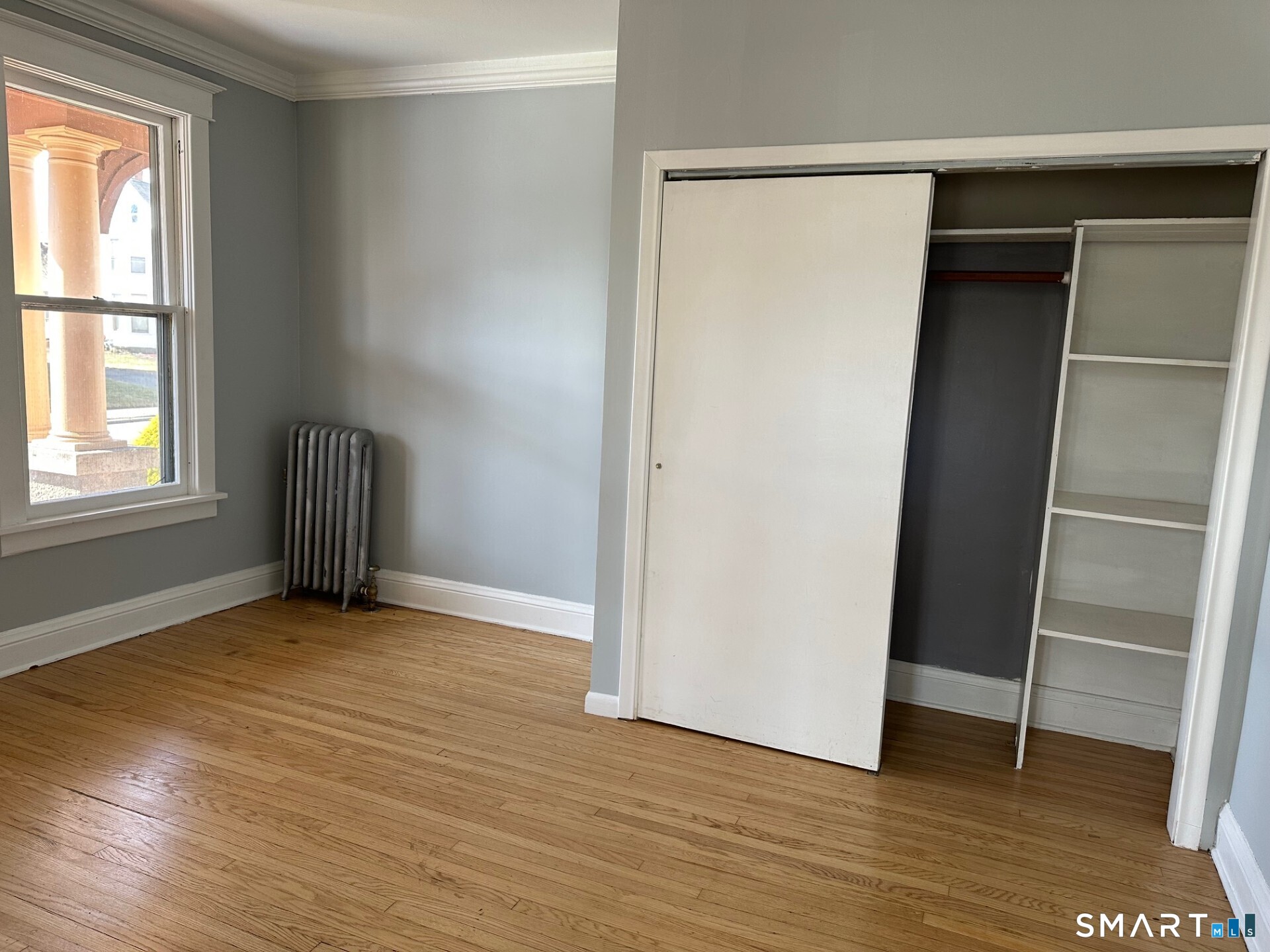 18 Taylor Street Torrington, CT 06790 - Photo 7 of 17 an empty room with wooden floor and a window