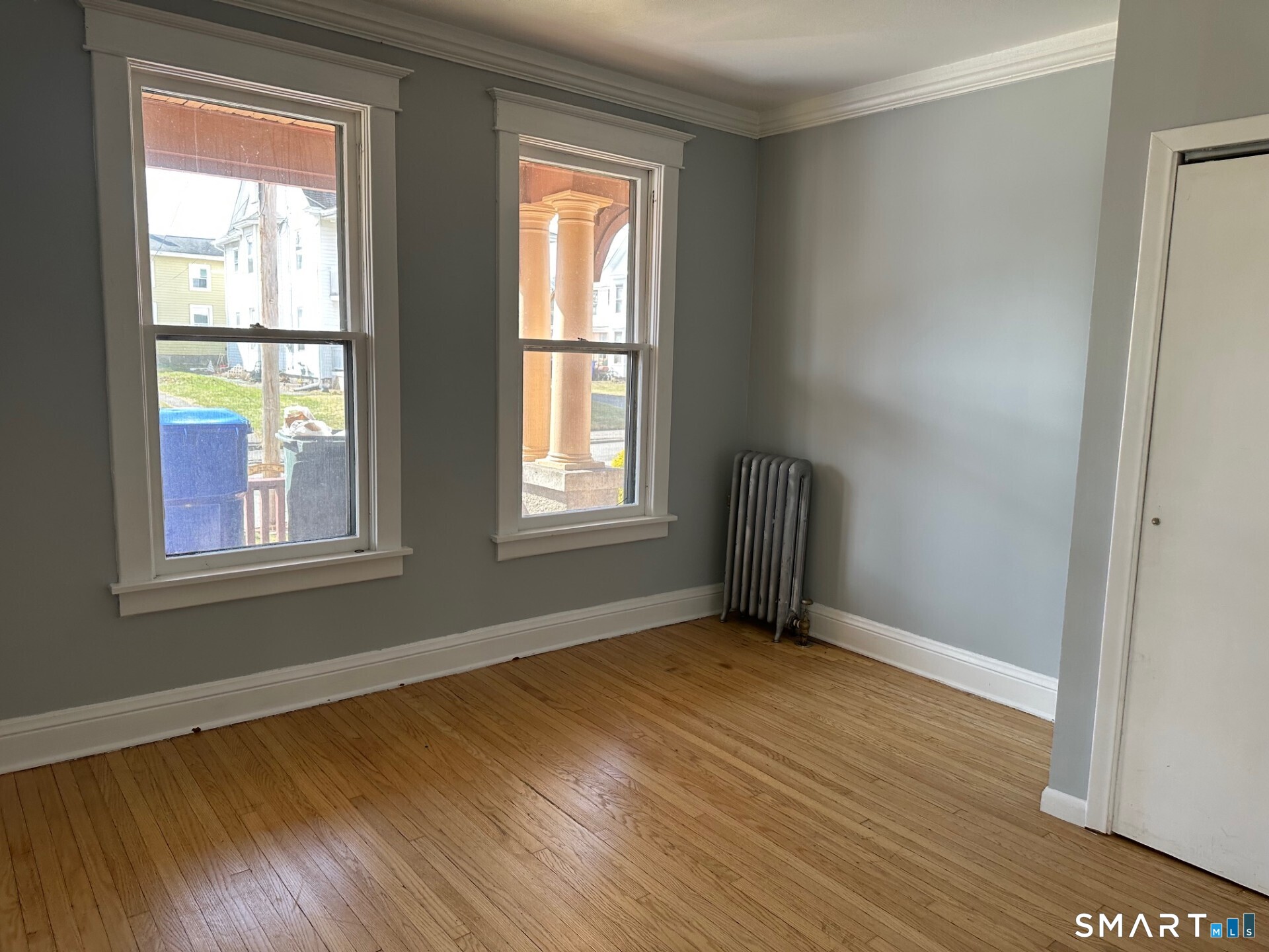18 Taylor Street Torrington, CT 06790 - Photo 8 of 17 an empty room with wooden floor and windows