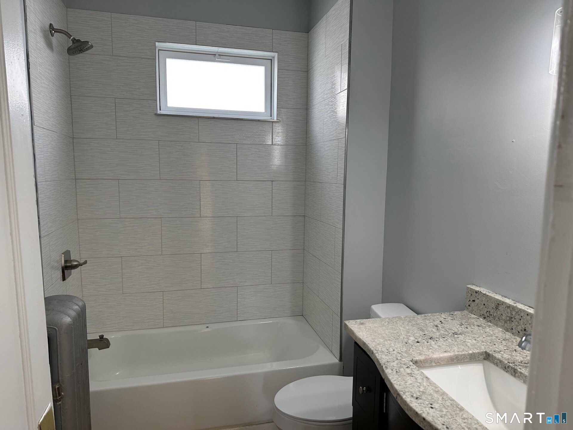 18 Taylor Street Torrington, CT 06790 - Photo 9 of 17 a bathroom with a granite countertop sink toilet and bathtub