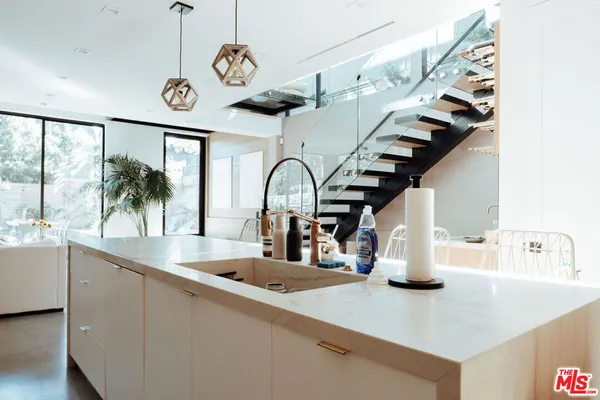 a kitchen with a refrigerator and a sink