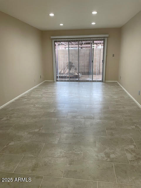 1827 East Kirkland Lane, Unit D Tempe, AZ 85288 - Photo 2 of 21 an empty room with wooden floor and windows