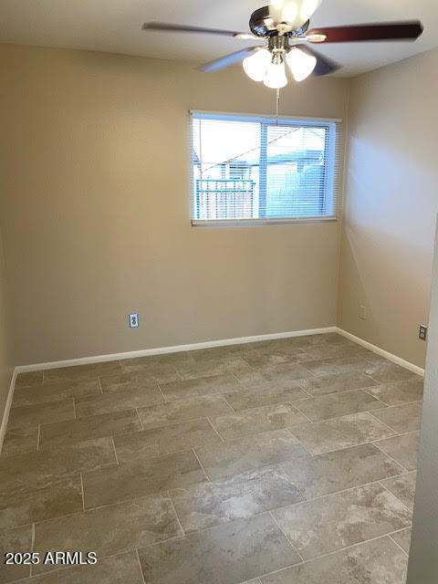 1827 East Kirkland Lane, Unit D Tempe, AZ 85288 - Photo 9 of 21 en empty room with windows and ceiling fan