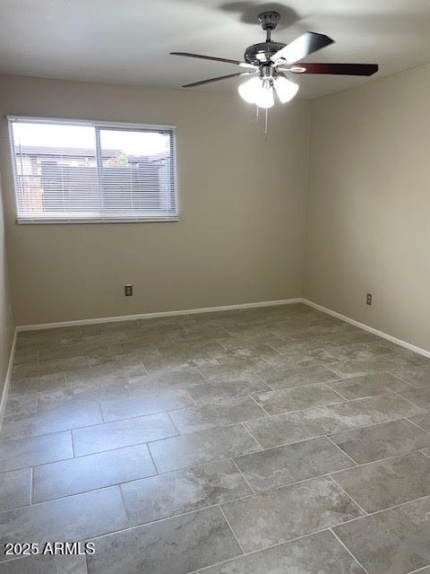 1827 East Kirkland Lane, Unit D Tempe, AZ 85288 - Photo 10 of 21 a view of a room with a ceiling fan and a window